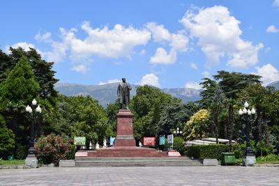 Statue in park against sky