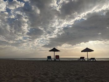 Dramatic view of empty beach against sky during sunset during covid-19