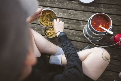 Woman preparing food at lake