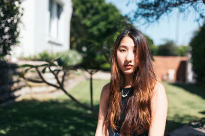 Portrait of young woman standing outdoors