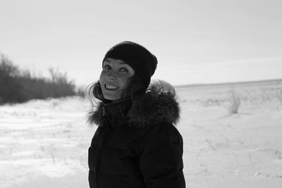 Portrait of woman standing on snow covered land