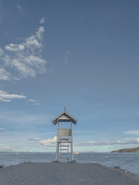 Lifeguard hut on beach against sky