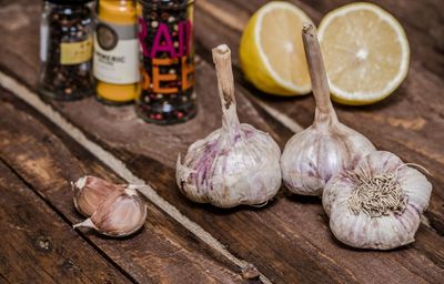 High angle view of spices with lemon on wooden table