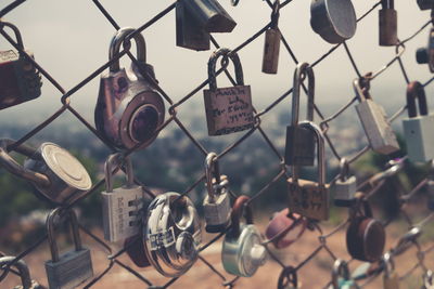 Close-up of padlocks hanging on railing