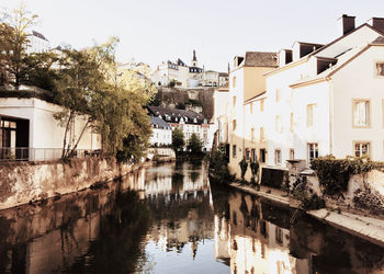 Canal amidst buildings against sky