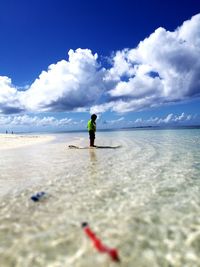 Man on beach against sky