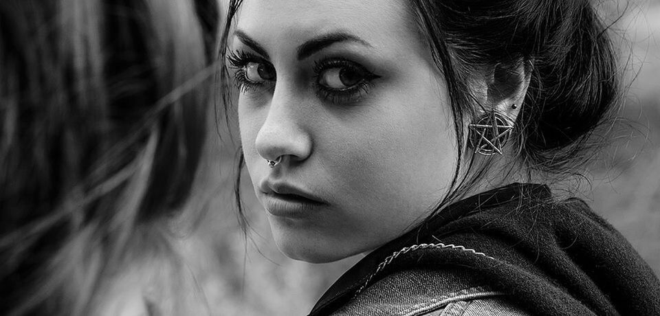 person, headshot, young adult, lifestyles, looking at camera, close-up, portrait, front view, young women, human face, leisure activity, focus on foreground, contemplation, head and shoulders, serious, indoors