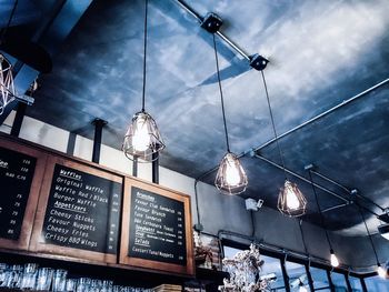 Low angle view of illuminated street light against building