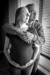 Midsection of young couple standing at home