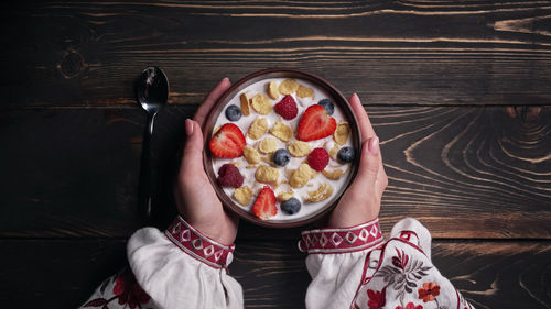 Midsection of woman having breakfast on table