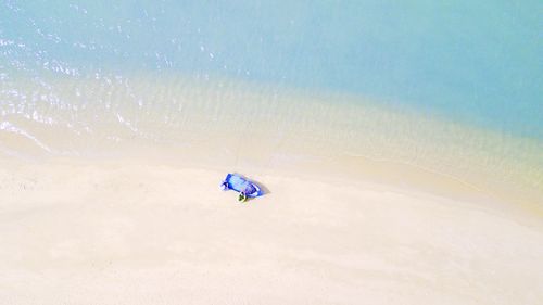 Person paragliding on blue sea