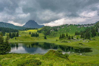 Scenic view of lake and mountains against sky