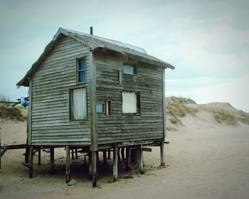 Built structure on beach against sky