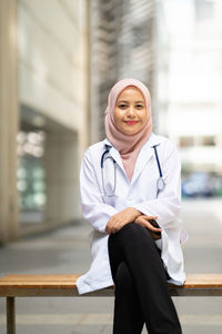 Female doctor sitting outdoors