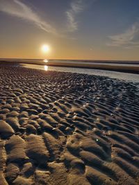 Scenic view of beach against sky during sunset