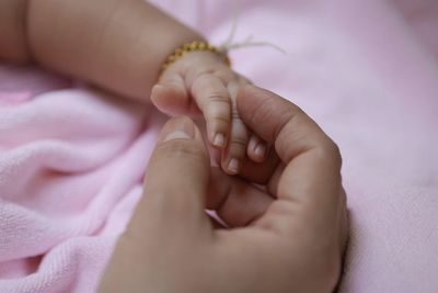 Close-up of hands holding baby feet