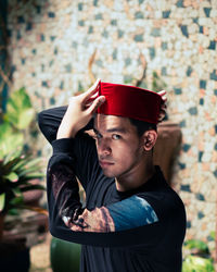 Portrait of man wearing hat standing outdoors