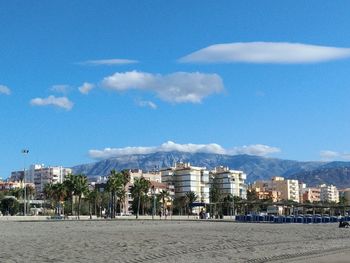 Scenic view of beach against buildings in city