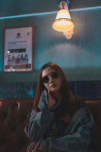 Young woman sitting on sofa