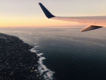 Cropped image of airplane flying over landscape