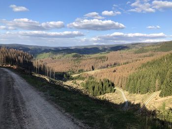 Panoramic view of road amidst landscape against sky