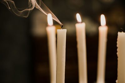 Close-up of lit candles in temple