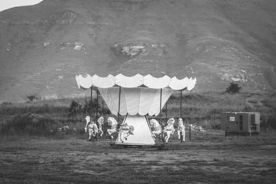 People on field by lake