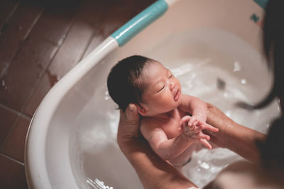 Midsection of baby girl in bathroom