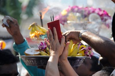 People with religious offerings at temple