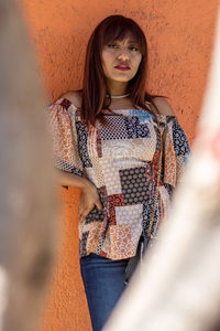 Girl in casual clothes posing on the city streets on a sunny day