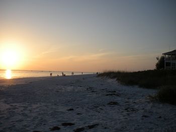 Scenic view of beach against sky during sunset