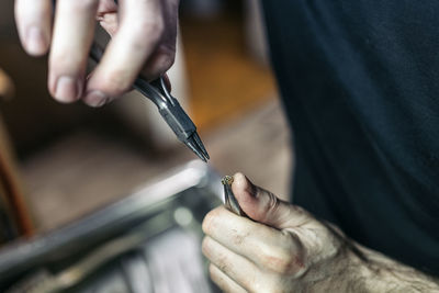 Midsection of man working on cutting board