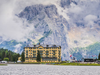 Panoramic shot of building by mountain against sky