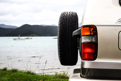 Close-up of vintage car on mountain against sky