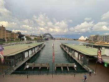 Bridge over river in city against sky