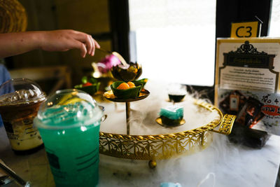 Midsection of woman holding food on table