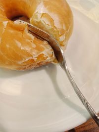 High angle view of donut in plate on table,cut cut cut