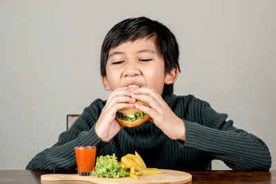 Full length of a boy eating food