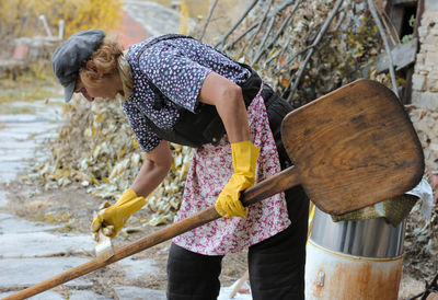 Woman painting on wood