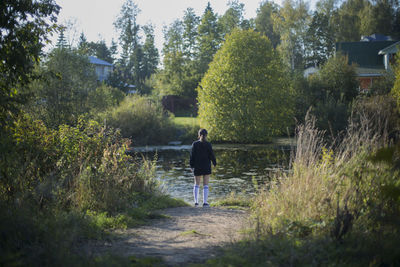 Rear view of man walking on grassland