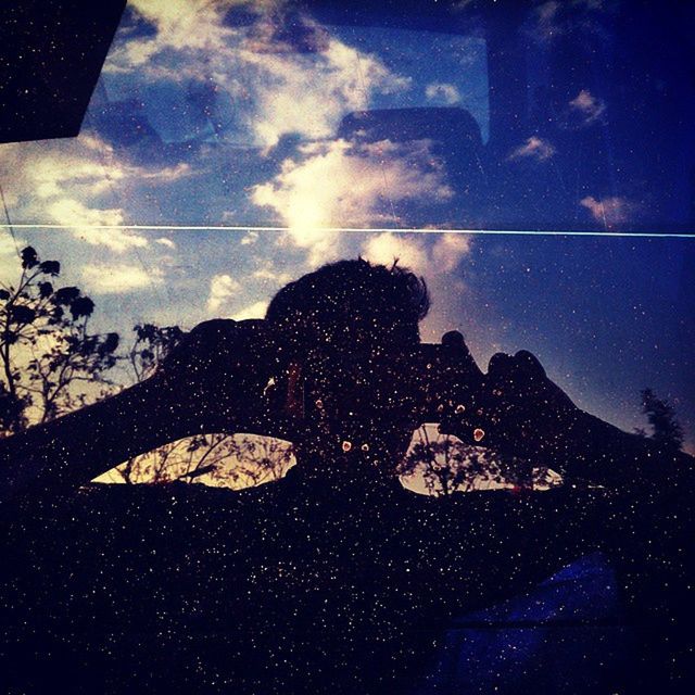 sky, silhouette, low angle view, cloud - sky, sunlight, cloud, window, nature, blue, outdoors, day, no people, reflection, dusk, weather, sun, close-up, beauty in nature, glass - material, shadow