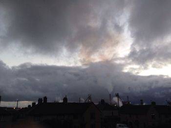 Buildings against cloudy sky