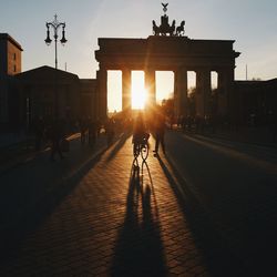 Silhouette of people in town square