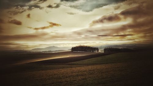 Scenic view of landscape against cloudy sky