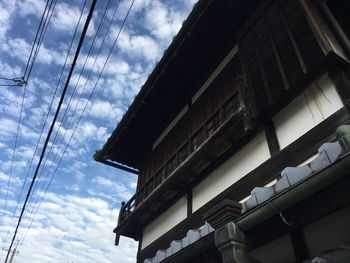 Low angle view of building against cloudy sky