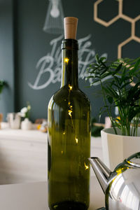 Glass green wine bottle with led lights in it in the decor of the kitchen or dining room