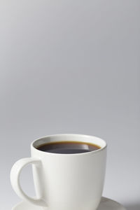 Close-up of coffee cup against white background