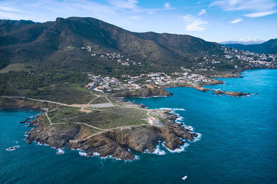 Aerial view of sea and mountains against sky