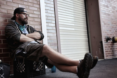 Side view of man sitting outdoors