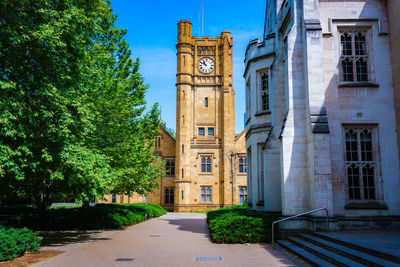 Clock tower amidst buildings in city